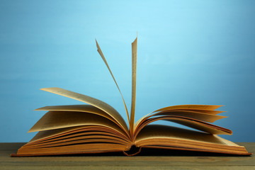 Open book on wooden background