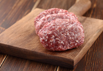 ground meat on a wood background