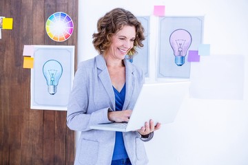 Fototapeta premium Creative businesswoman holding laptop computer 