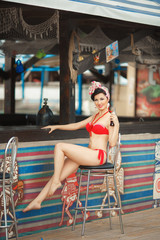 Beautiful young woman bikini girl at beach pinup style