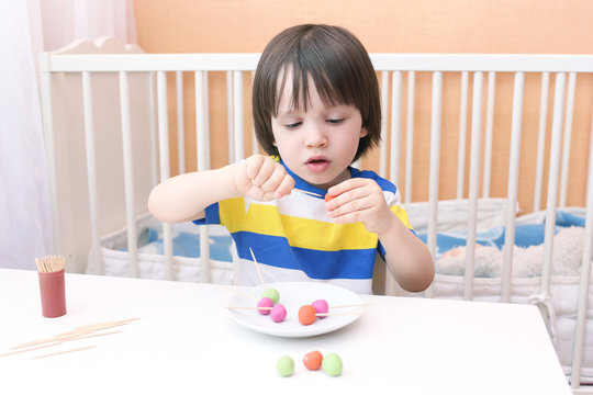 Lovely little boy made lollipops of playdough and toothpicks