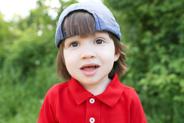 Portrait of little boy outdoors in summer