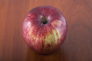 Red apple on a wooden table