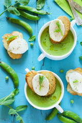 Green pea soup with croutons and cheese.