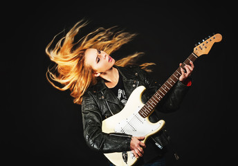 young woman with waving hair play electric guitar isolated on bl - obrazy, fototapety, plakaty