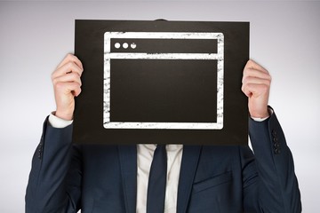 Composite image of businessman holding board