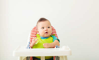 baby child eating in chair