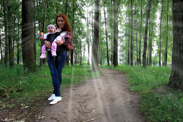 young family on a walk in the park sunshine