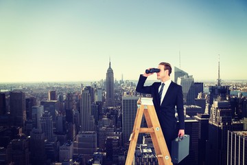 Fototapeta na wymiar Composite image of businessman looking on a ladder