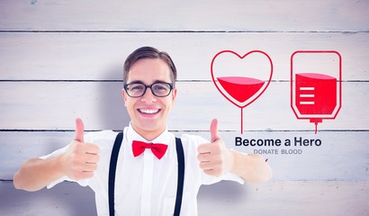 Composite image of geeky young hipster showing thumbs up