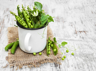 Metal cup with fresh peas
