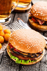 Delicious burger with fried potato balls and beer