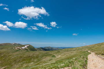 Road through the amazing spring mountain under blue sky