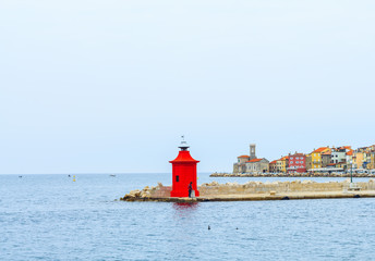View of red light house and city of Piran on back ground, Slovenia.