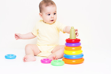 Beautiful baby playing with colorful toy
