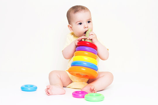 Beautiful baby playing with colorful toy
