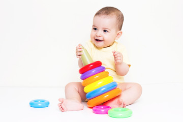 Fototapeta na wymiar Beautiful baby playing with colorful toy 