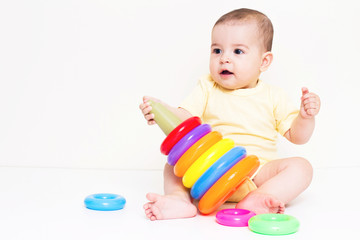 Beautiful baby playing with colorful toy
