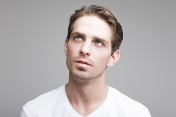 Fototapeta premium Pensive man in a white T-shirt