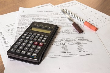 Business composition of bills, calculator, pen and various statistics