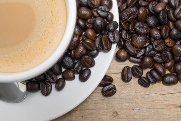 Coffee cup and saucer on a wooden table. Dark background.