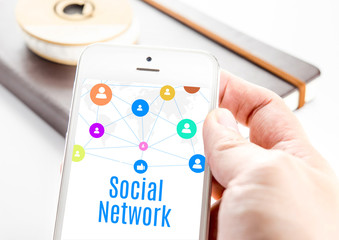 Close up hand holding smart phone with Social network word and i