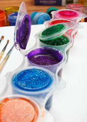 Paint brushes with opened paint bucket