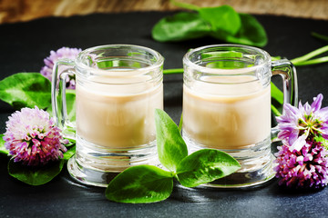 Coffee and Irish cream liqueur with flowers and clover shamrock