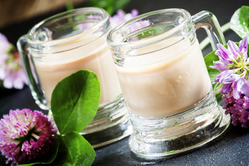 Coffee and Irish cream liqueur with flowers and clover shamrock