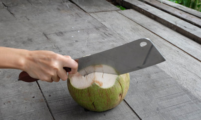girl cutting coconut by chopper