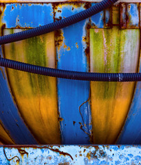Corrosion, paint and hoses create a colorful pattern on an agricultural chemical tank in Texas - obrazy, fototapety, plakaty