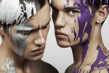men with silver and violet paint on face