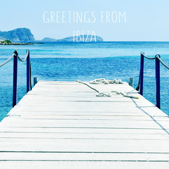 boardwalk over the sea in Ibiza Island, Spain, and the text gree
