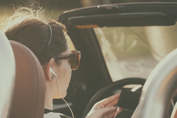 Retro photo of woman listening music in car while driving - 85826725