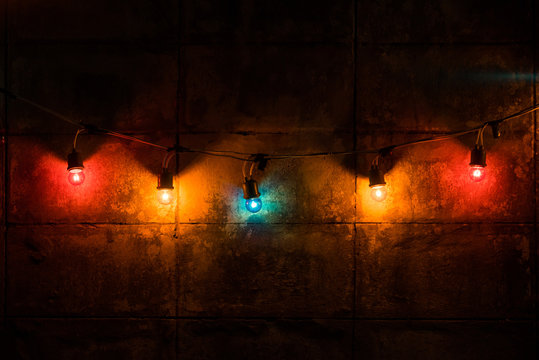 Color light bulb decor on wall in night.