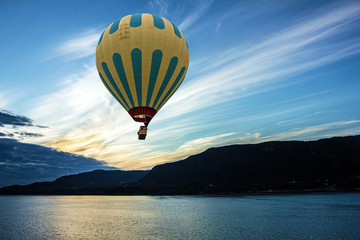 Hot air balloon over sea, Geiranger, Norway. Sunrise, Norwegian