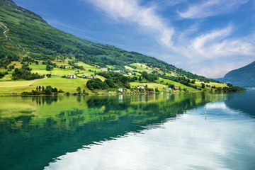 Fototapeta premium Village houses in rural town Olden, Norway. Seascape.