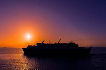 Obraz premium Ferry cruising into the Caribbean sunset Trinidad and Tobago 