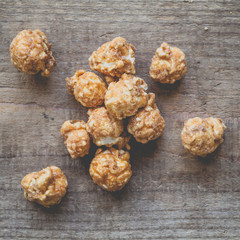 Almond and caramal popcorn on wood background