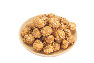 Almond and caramal popcorn on white background
