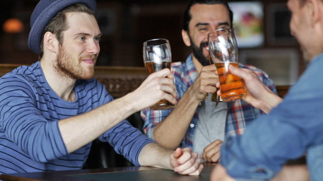happy male friends drinking beer at bar or pub
