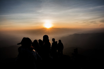 group people watching the sunset