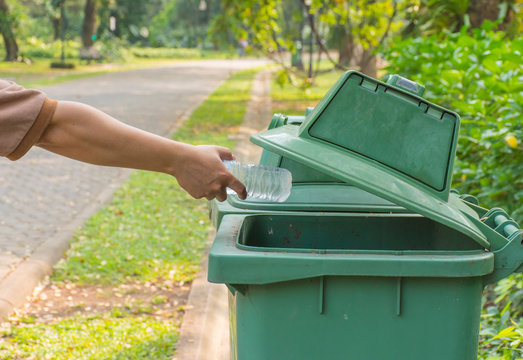 Tossing Bottle Of Plastic In Trash