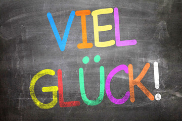 Good Luck (in German) written on a chalkboard