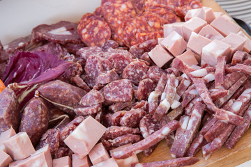 Assortimento di salami italiani presentati su tagliere di legno