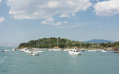 Fototapeta na wymiar Small island with sailing boats in bosphorus