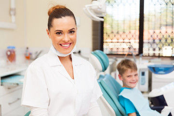 Fototapeta premium young female dentist and little patient