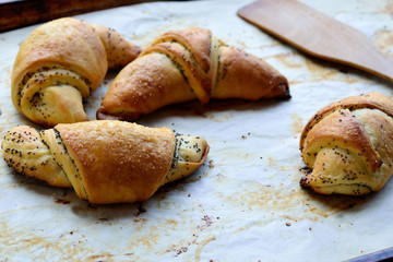 Rolls of puff pastry with poppy seeds.