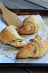 Rolls of puff pastry with poppy seeds.