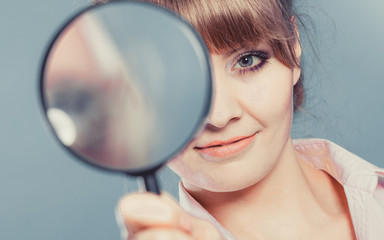 Woman holding magnifying glass